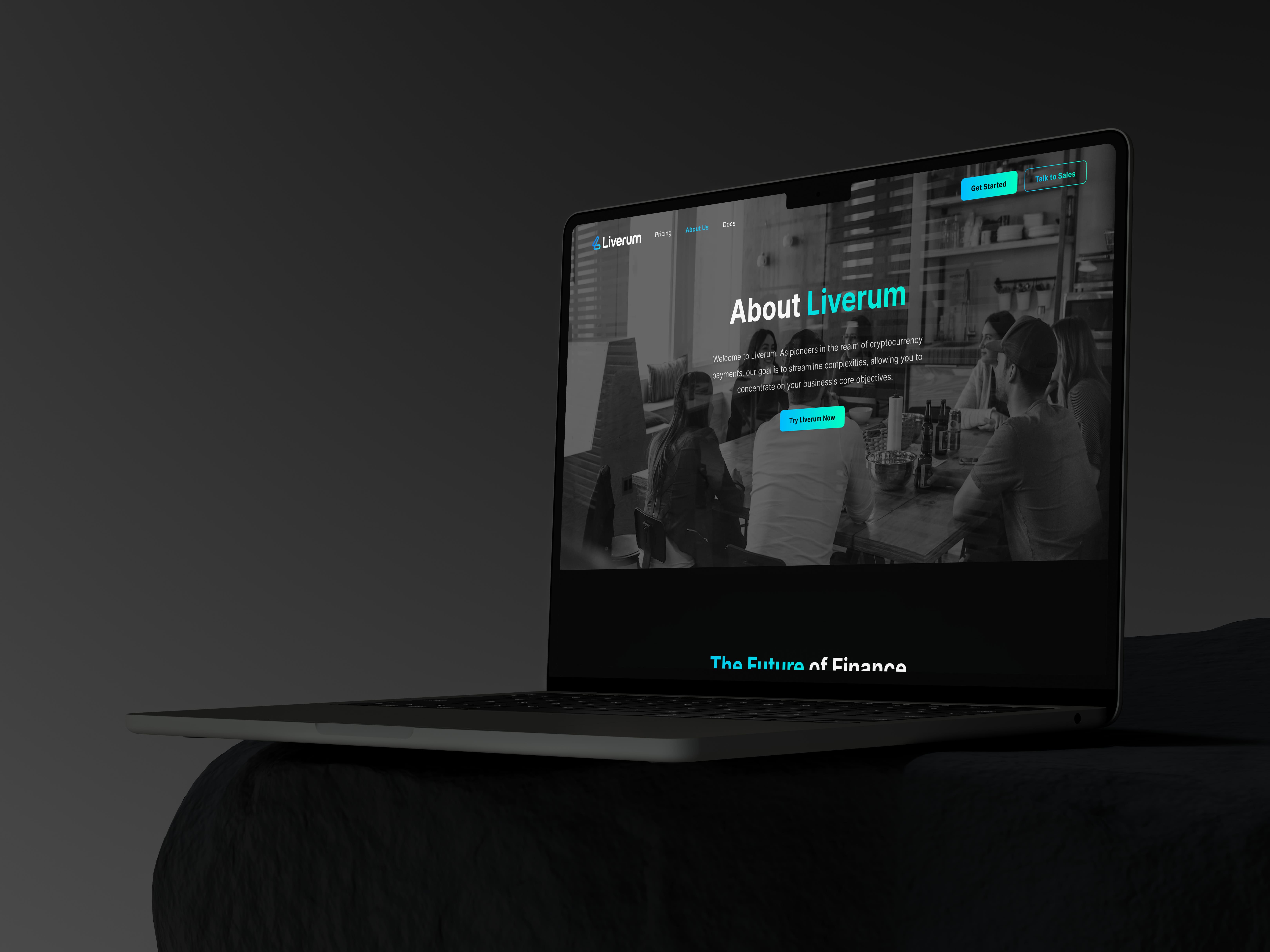 Liverum 'About Liverum' hero page with a team photo, shown on a laptop in a dark setting